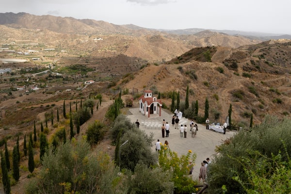 A small chapel and white ceremony chairs overlooking the surrounding hills