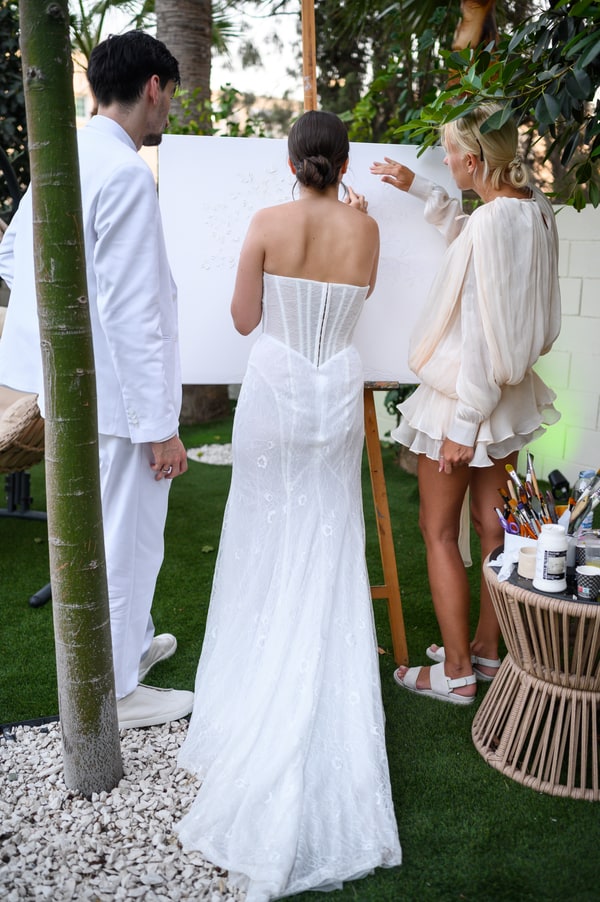 The bride and groom talking with their guests outdoors
