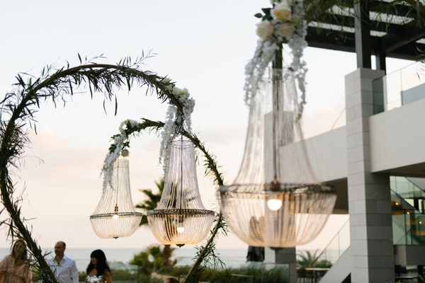 Crystal chandeliers suspended above the reception as the light softens