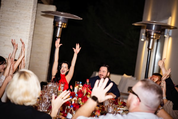 Guests raising their glasses at the birthday table