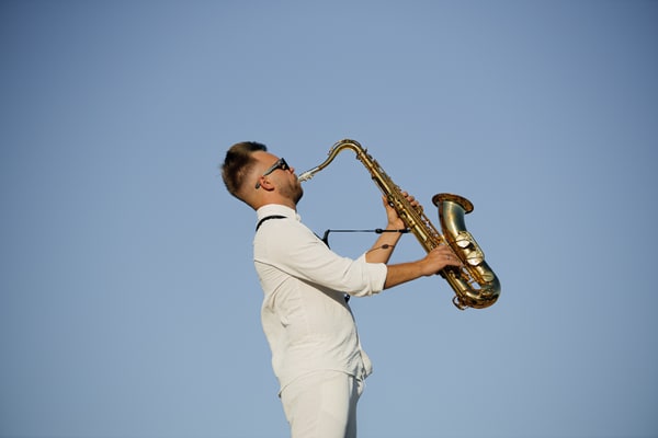 A saxophonist performing at the seaside picnic