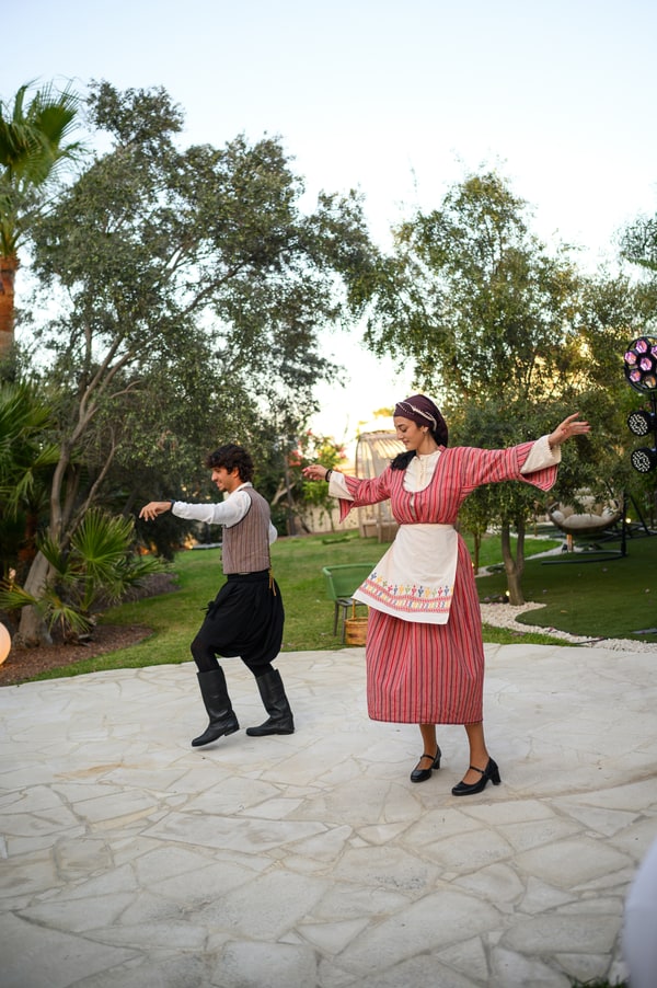 Performers and wedding guests dancing in the garden