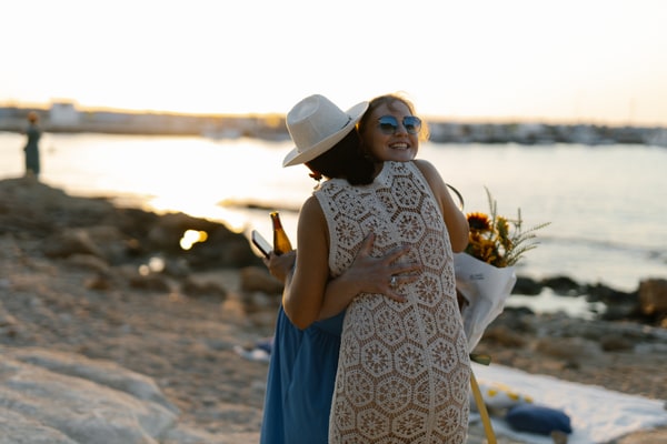 Guests chatting and posing together at the seaside picnic
