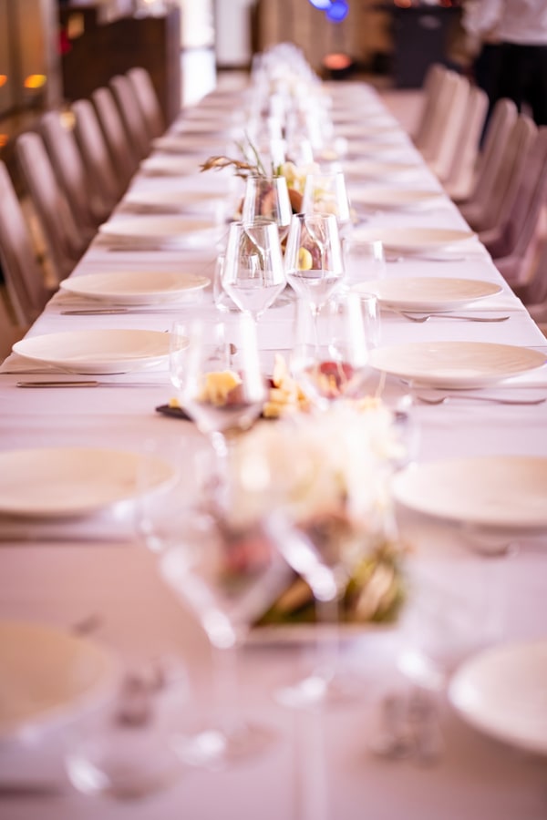 A long dining table with flowers and festive decorations indoors