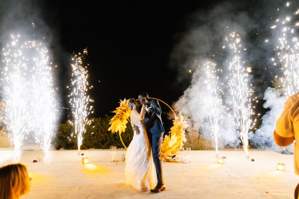 Nathalie and Joël dancing between fountains of sparks after dark