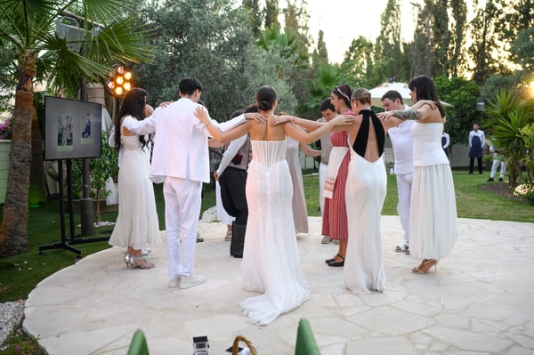 Performers and wedding guests dancing in the garden