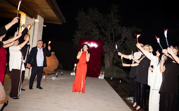 Guests holding sparklers outdoors at night