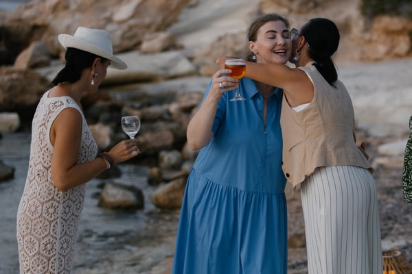 Guests chatting and posing together at the seaside picnic