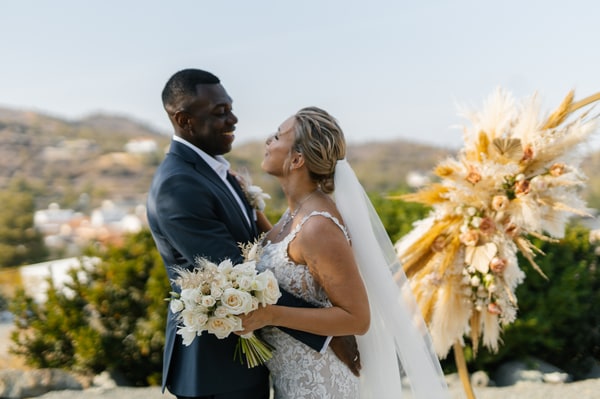 Nathalie and Joël together beside a circular floral wedding arch