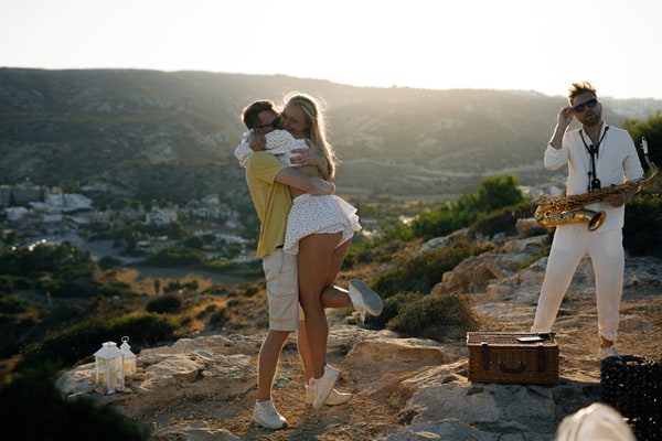 A couple enjoying live saxophone music above the sea