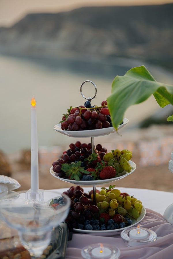 Fresh fruit on a tiered stand on the picnic table