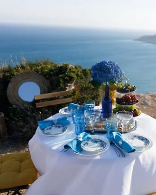 Blue-and-white table setting overlooking the sea