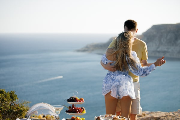 A couple dancing and embracing beside the sea