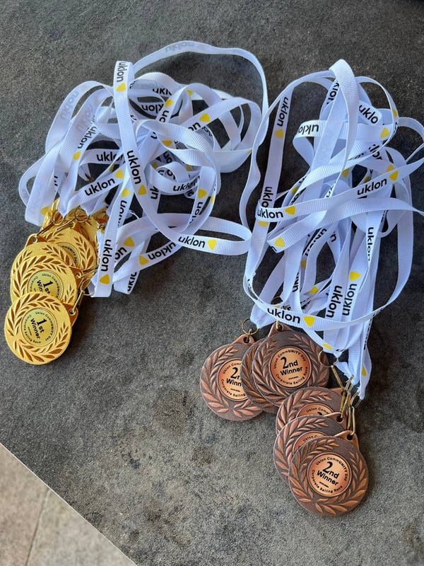 Medals with white ribbons laid out on a table