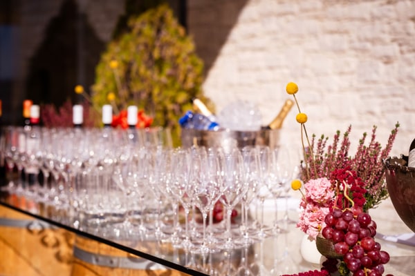 Glasses, bottles and grapes arranged at the bar