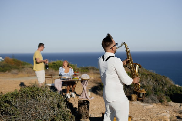 A saxophonist performing at the seaside picnic